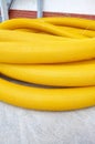 Yellow coil land drainage pipe on the ground, it is used to remove excessive water from fields and gardens