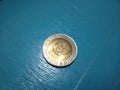 Yellow coin rupiah from indoneia on top view in 1992 year