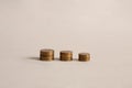 Yellow coins are on the table in a pile. Coins in three piles