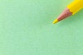 Yellow color pencil on green color paper arranged diagonally Royalty Free Stock Photo