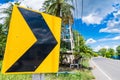 Yellow color right curve sign plate at the highway. Black color arrow on yellow plate. road safety symbol