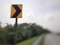 Yellow color right curve sign plate at the highway Royalty Free Stock Photo