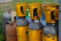 Yellow color steel carbon dioxide cylinder next to gas cylinders