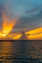 Yellow color sun rays through clouds during sunset in Indian ocean Royalty Free Stock Photo