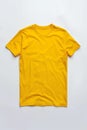 yellow color t-shirt lying on a white background