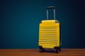 Yellow color traveling suitcase on dark background with copy space