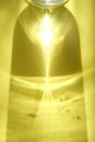 Yellow colored abstract background with light and shadows caustic effect. Light passes through a glass. Blurred light refraction