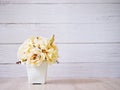 Yellow colored artificial rose flowers bouquet in pot on table Royalty Free Stock Photo