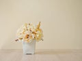 Yellow colored artificial rose flowers bouquet in pot on table Royalty Free Stock Photo