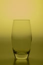 Yellow colored concept art with a drinking glass in a studio