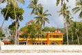 Yellow-colored house in a tropical garden