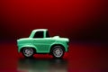 Yellow colored toy model car on a red background Royalty Free Stock Photo