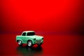 Yellow colored toy model car on a red background Royalty Free Stock Photo