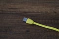 Colored USB type cable staying on dark wooden table. Royalty Free Stock Photo