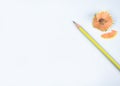 A yellow colored wood pencil crayon placed beside some pencil shavings Royalty Free Stock Photo