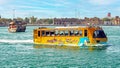 Yellow colorful amphibian water wonder taxi bus for tourist harbor city sightseeing tours on Dubai creek river Royalty Free Stock Photo