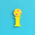 Yellow column with soccer ball on bright blue background in past Royalty Free Stock Photo