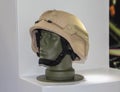 Yellow combat helmet on the green doll with white background.