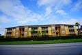 Yellow condos or apartments and green ivy wall