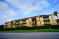 Yellow condos or apartments and green ivy wall