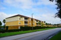 Yellow condos or apartments and green ivy wall