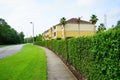 Yellow condos or apartments and green ivy wall