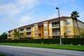 Yellow condos or apartments and green ivy wall