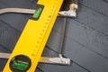 Yellow construction bubble spirit level and fretsaw Royalty Free Stock Photo