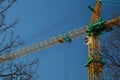 Yellow construction crane against a blue sky