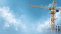 Yellow construction crane against blue sky with white clouds Royalty Free Stock Photo