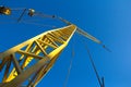 A small construction crane on a background of blue sky. Industrial background Royalty Free Stock Photo