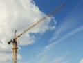 Yellow construction crane in front of blue sky - construction site Royalty Free Stock Photo