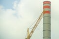 Yellow construction crane with a water tank white with orange with the sky Royalty Free Stock Photo