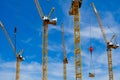 Yellow construction cranes on blue sky backgrounds Royalty Free Stock Photo