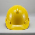 Yellow construction hard hat made of durable plastic, designed for safety. It has a Royalty Free Stock Photo
