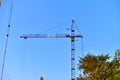 Yellow construction tower crane in the city against the sky Royalty Free Stock Photo