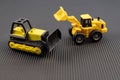 Yellow Construction Toy Vehicles on Black Background Royalty Free Stock Photo