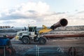 a construction vehicle pulling a large tube out of the ground