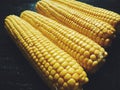 yellow corn on black, vegetables