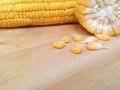 Yellow corn and corn kernels on wooden table. Royalty Free Stock Photo