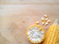 Yellow corn and corn kernels on wooden table. Royalty Free Stock Photo