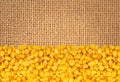 Yellow corn gran over linen texture Royalty Free Stock Photo