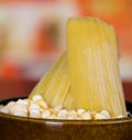 A yellow corn inside of a Crock pot with a couple of humitas Royalty Free Stock Photo