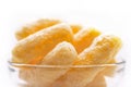 Yellow Corn Puffs in a Glass Bowl. Crunchy Flavored Puffed Snacks. Party, Movie, TV, Game Snacks Royalty Free Stock Photo