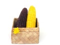 Yellow corn and purple corn in the box weave from plants.