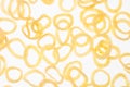 Yellow corn sticks rings on white background, pattern, top view. Royalty Free Stock Photo