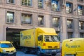 Yellow Correos post trucks in the street of Baecelona, Spain