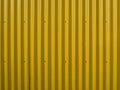 Yellow corrugated wall. Yellow steel background. Mounted with screws. Can be used as a background.