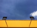 Yellow corrugated zinc sheet wall against blue sky Royalty Free Stock Photo