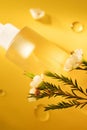 Yellow cosmetic bottle and oil drops Royalty Free Stock Photo